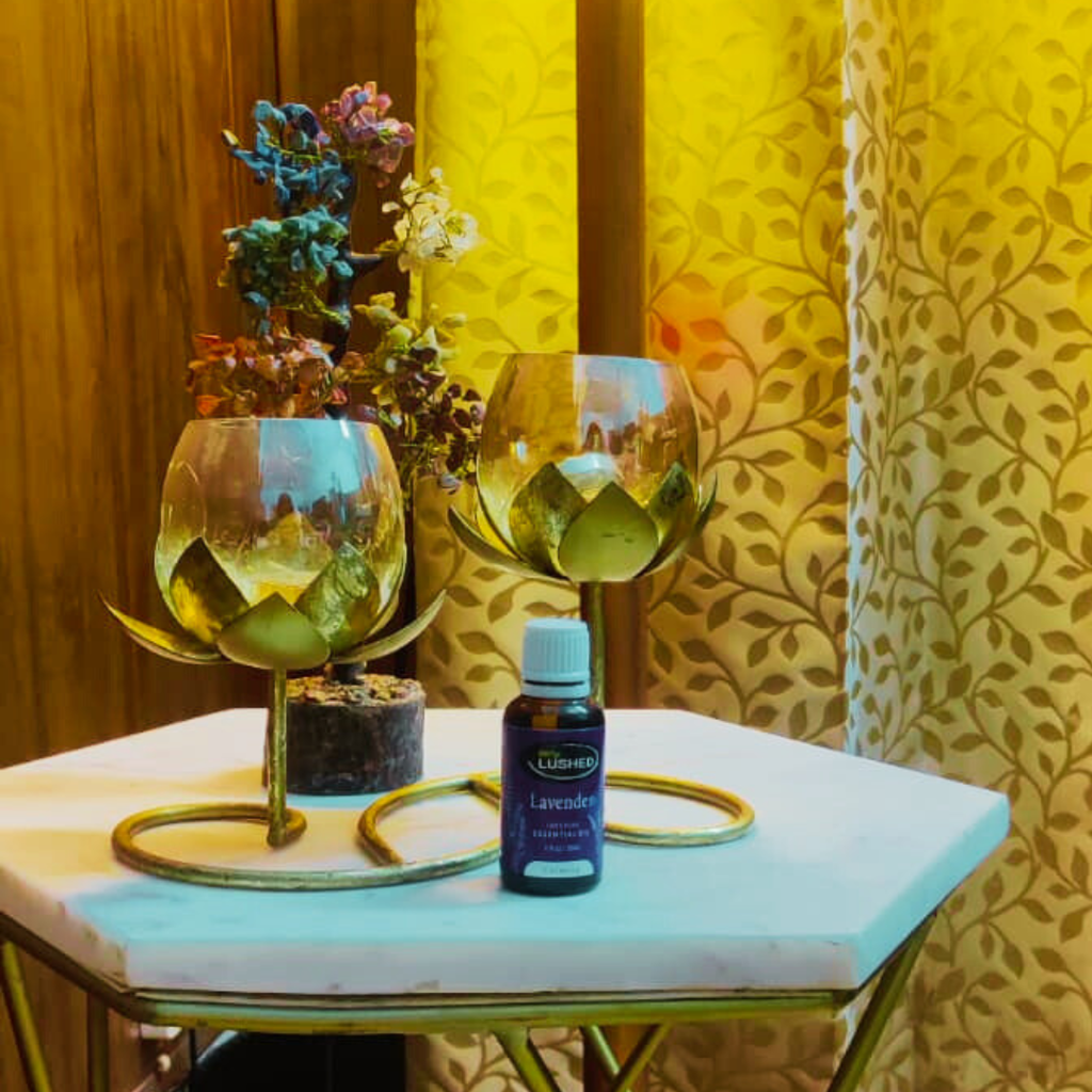 Herbal Home Fragrance oil styled on table with candles and glasses