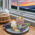 Lavender wax melts glowing in electric diffuser at sunset by window
