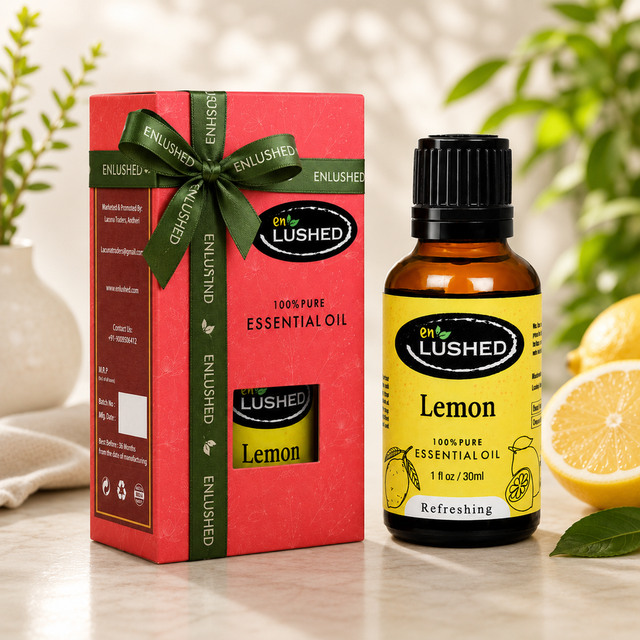 Lemon Essential Oil bottle with gift box, fresh lemons and green ribbon