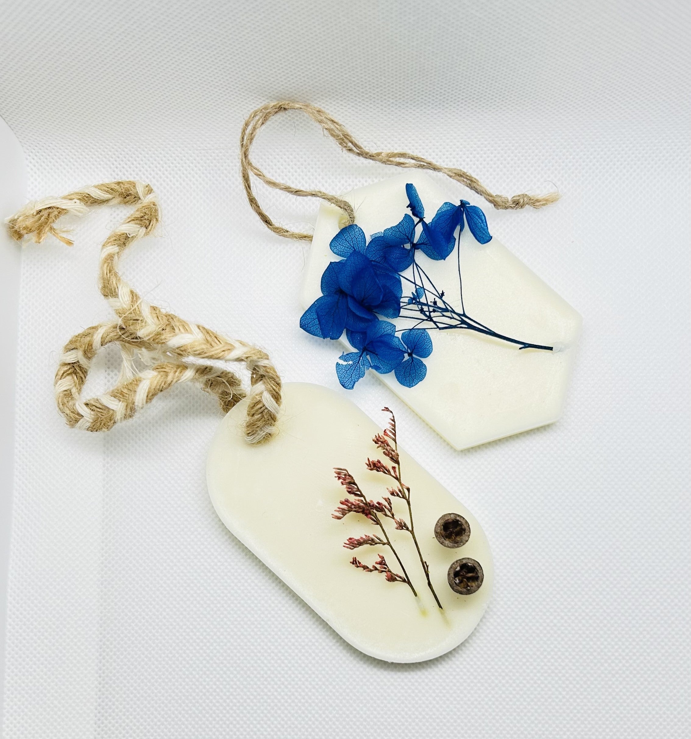 Wax air freshener pair with dried blue flowers on jute cord