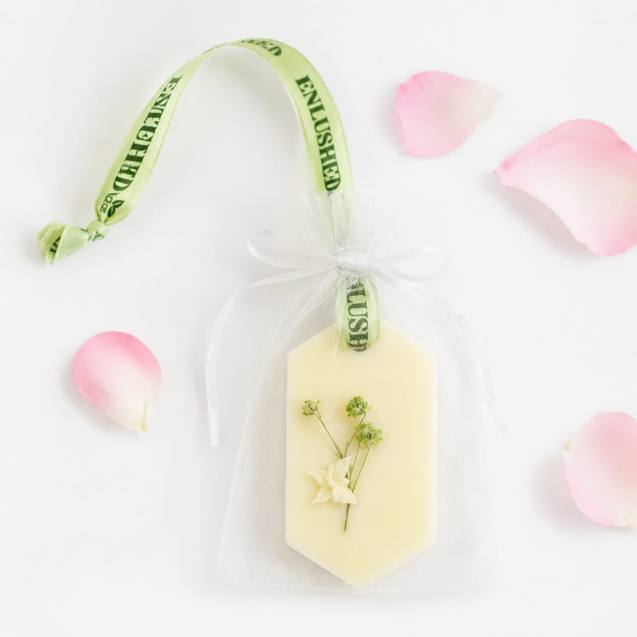 Scented wax tablet for wardrobe hanging with ribbon and rose petals